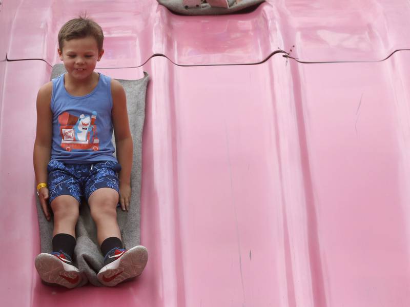 Beckett Jackson, 7, of Crystal Lake, slides down the fun slide during Lakeside Festival on Friday, July 1, 2022, at the Dole and Lakeside Arts Park, 401 Country Club Road in Crystal Lake. The festival continues from noon to 11 p.m. July 2 and noon to 10 p.m. July 3. The festival features bands on two outdoor stages, food and drinks, a baggo tournament, and carnival rides and games. Among the activities for kids are face painting, a balloon twister, a stilt walker, team mascots and a magician.