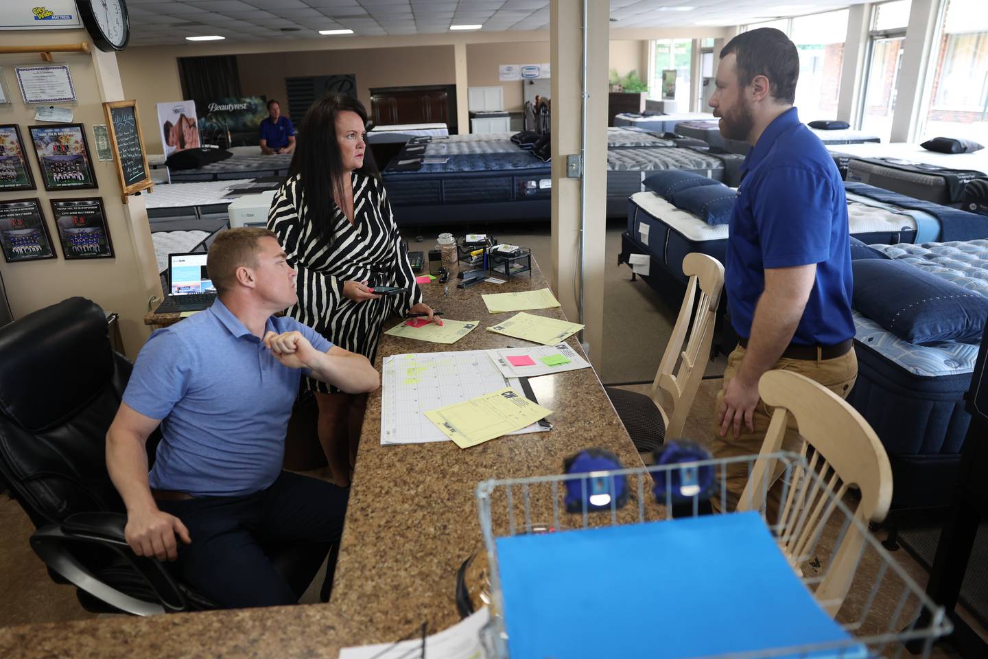 Owners Ross Brocies, left, and his sister DeAnna Borracci talk with their Sales Manager Austin Park at the family-owned City Wide Mattress store on Monday, June 12, 2023 in Shorewood.