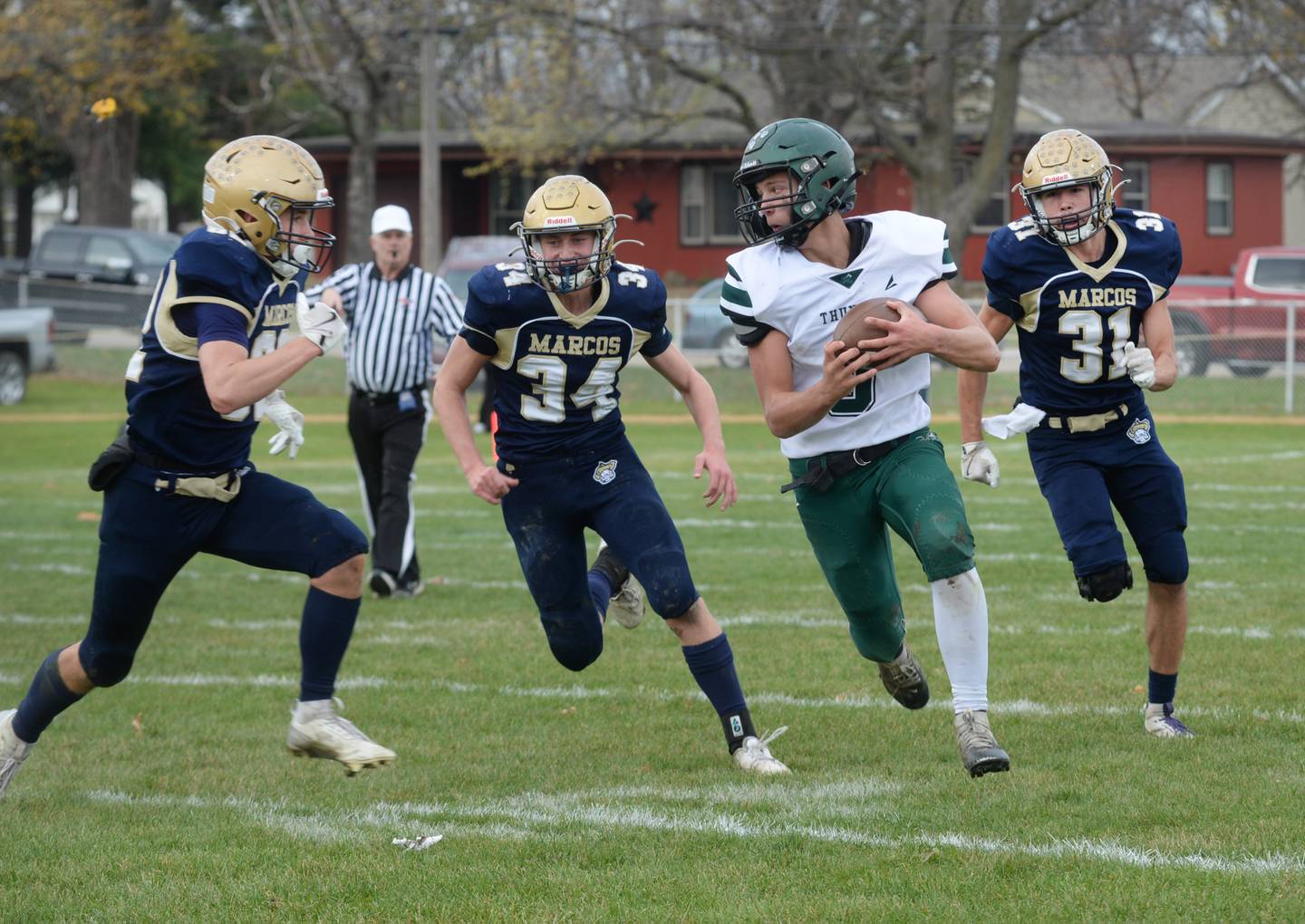 Polo's Elias Perez (32), Gage Zeigler (34), and Noah Dewey (31) zero in on West Carroll quarterback Jacoby Cropper (5) during 8-man football playoff action on Saturday, Nov. 9, 2024 at Polo High School.