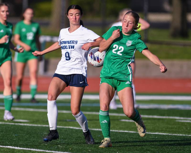 Downers Grove South's Gianna Lamb (9) and York's Avery O'Brien (22) battle for the ball during the regional title game on Friday May 23, 2025, held at York High School.