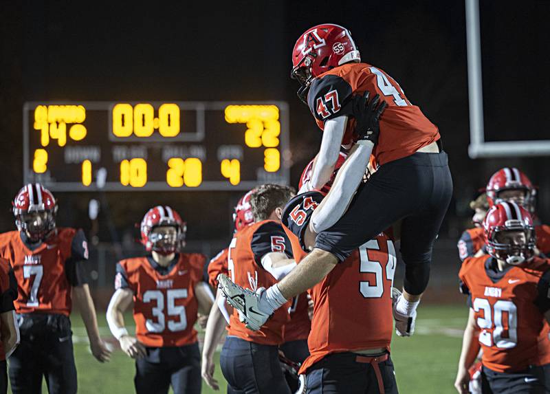 Amboy’s Jose Lopez is lifted by teammate Ian Sundberg after the Clipper’s 74-22 win over Ridgewood in the I8FA championship Friday, Nov.17, 2023 at Monmouth College.