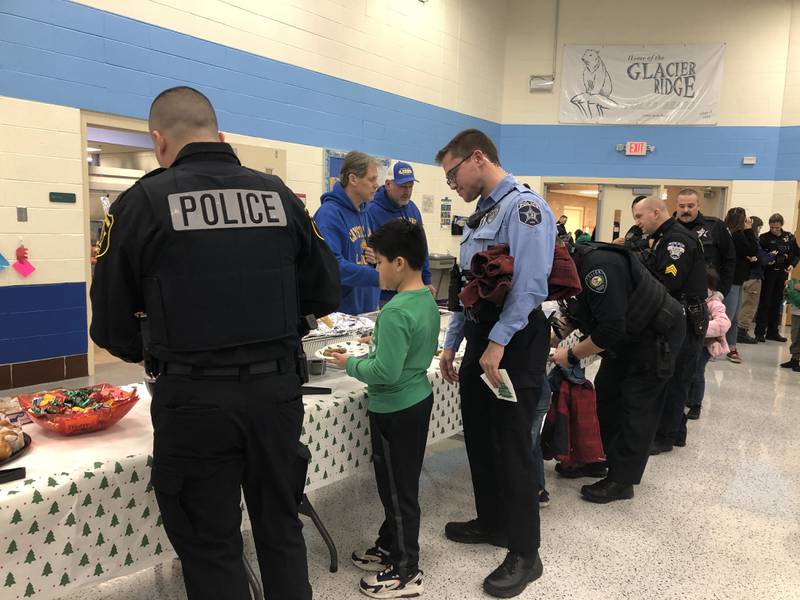 Students and police officers get breakfast during the Shop with a Cop event Dec. 3, 2023 in Crystal Lake