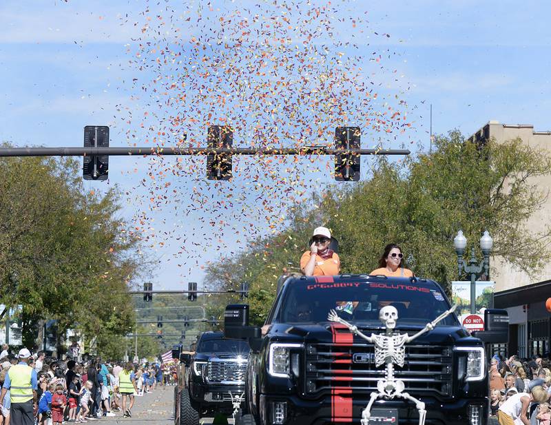 The Ottawa Fall Fest Committee parade entry shoots confetti into the air along LaSalle St Ottawa Sunday during the Fall Fest Parade.