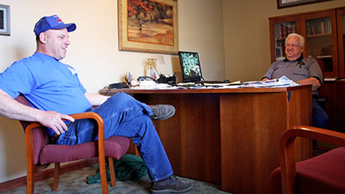 Newly elected Nunda Township Highway Commissioner Mike Lesperance (left) sits with ousted commissioner Don Kopsell Thursday, May 2, 2013. The two political rivals put politics aside to help flood victims as heavy rains overflowed the Fox River last month.