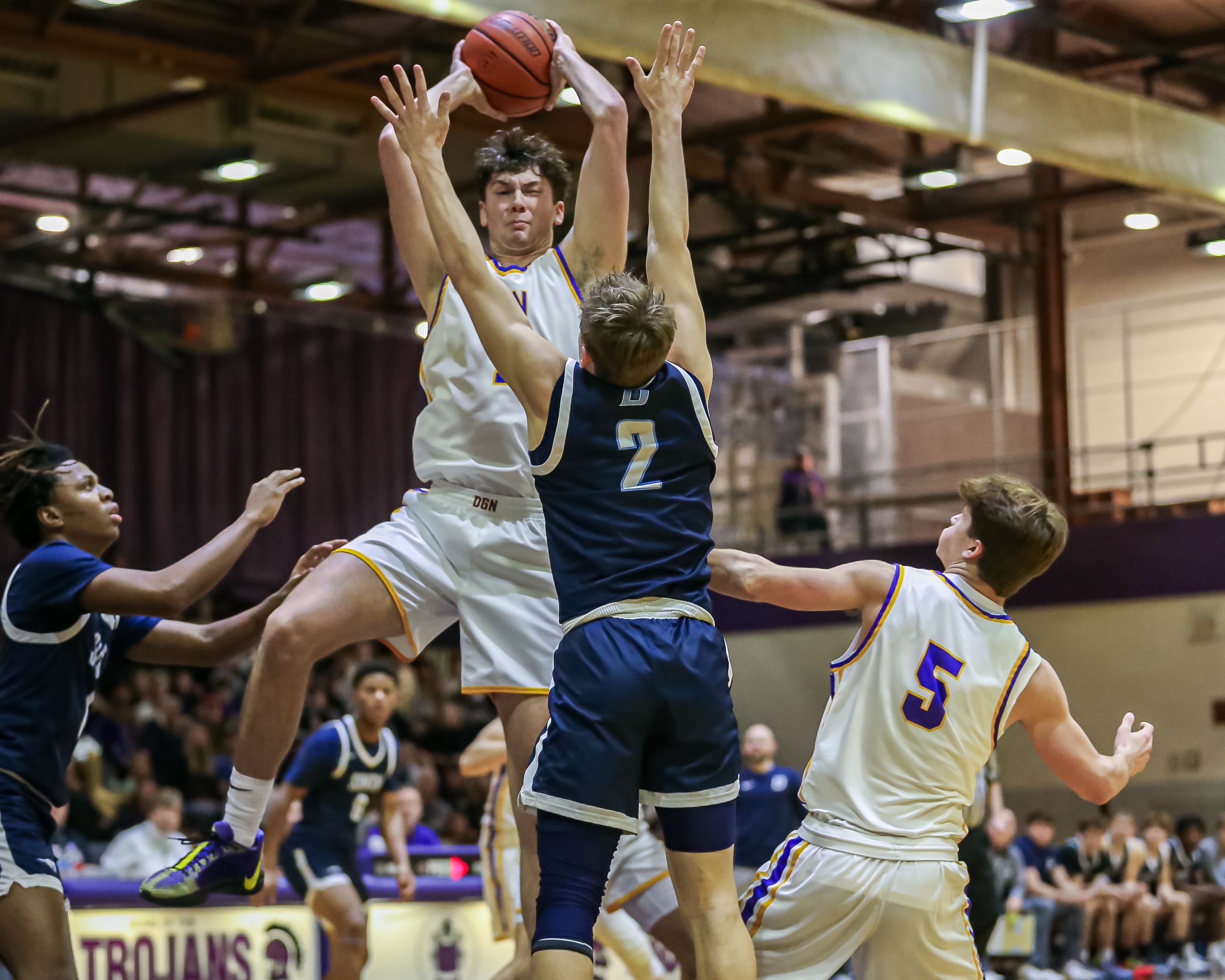 Downers Grove North's Jake Riemer (1) grabs a rebound during basketball game between Downers Grove South at Downers Grove North. Dec 16, 2023.