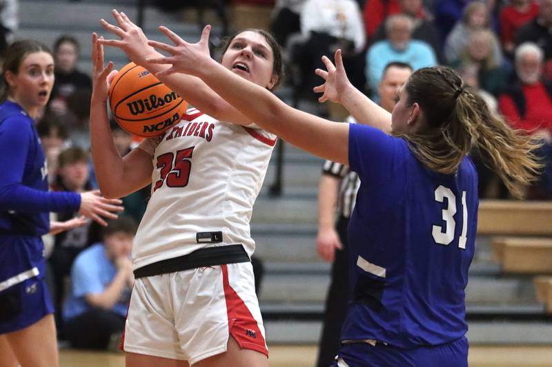 Huntley’s Paula Strzelecki, center, gathers the ball under the hoop against Lake Zurich in IHSA Class 4A Sectional girls basketball action on Tuesday, Feb. 25, 2025, at Huntley High School in Huntley.