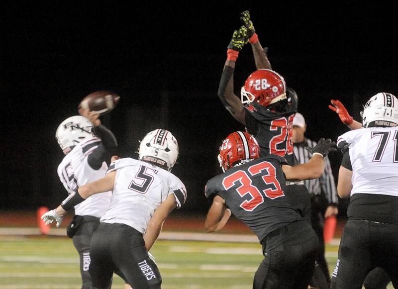 Plainfield North quarterback Nicholas Darwish (15) throws a pass that is blocked by Yorkville defender Bryce Griffin (28) during a varsity football game at Yorkville High School on Friday, Oct. 20, 2023.