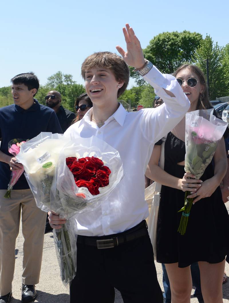 Daniel Ciesla waves to his family member during the Downers GroveSouth graduation ceremony Sunday May 21, 2023.
