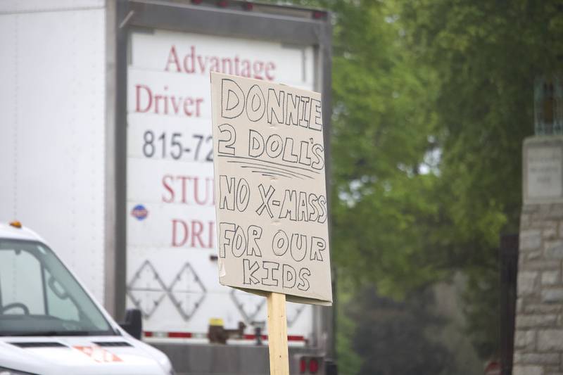 A sign on Thursday, May 1, 2025, at a Joliet rally that was critical of U.S. Donald President’s comments that his tariff policies may cause children to have "two dolls instead of 30 dolls." More than 20 people attended the rally held near the busy West Jefferson Street and the Joliet Regional Airport.