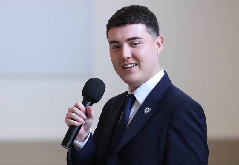 Andrew Miller, branch manager at Old National Bank, accepts the Outstanding Business Award on behalf of the bank Thursday, March 5, 2026, during the Sycamore Chamber of Commerce Annual Meeting in Memorial Hall at St. Mary's Catholic Church in Sycamore.