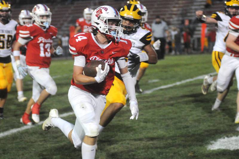 Ottawa's Archer Cechowicz (14) runs past Harvard's Kevin Salas at King Field on Friday, Sept. 8, 2023.