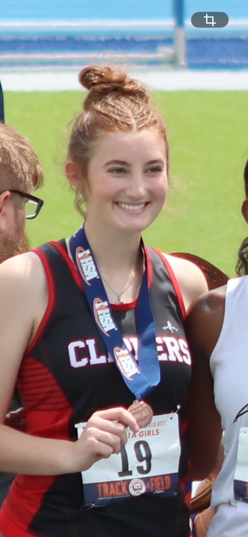 Ohio senior Jillian Anderson shows off her sixth-place medal in the high jump for the Amboy co-op.
