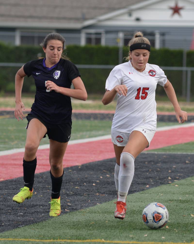 Glenbard East's Hope McKenna keeps the ball from Downers Grove North's Katelyn Hennelly during their regional final game Friday May 20, 2022.
