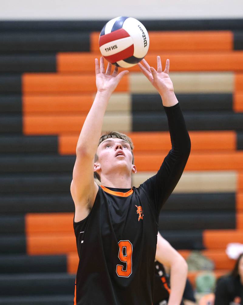 DeKalb’s Nolan Knutson sets the ball Tuesday, April 21, 2026 during their match against Naperville North JV at DeKalb High School.