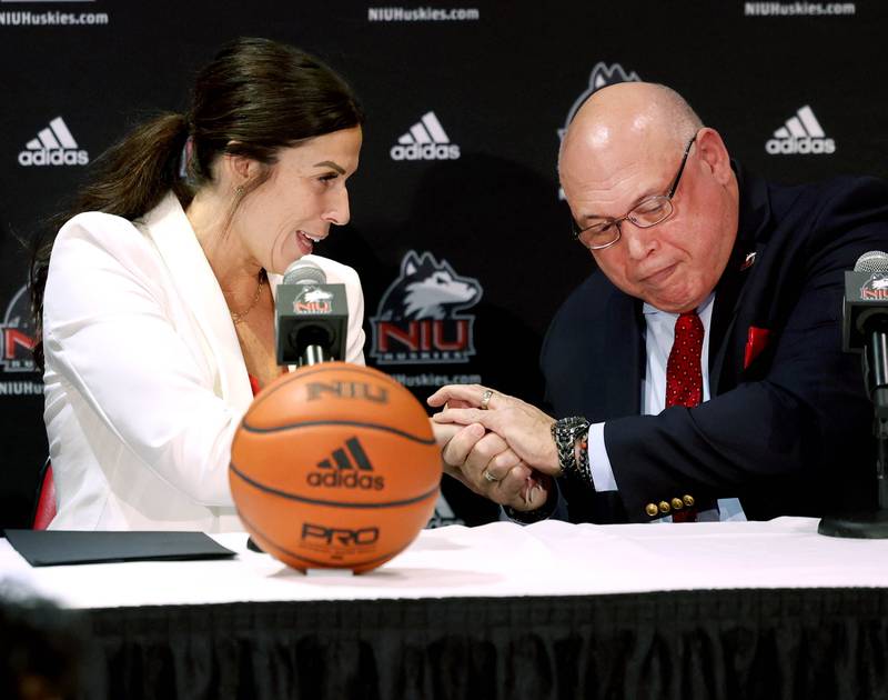 Sean Frazier, vice president and director of athletics and recreation at Northern Illinois University, shakes Jacey Brooks’ hand as she is introduced as the new NIU women’s basketball coach Wednesday, April 9, 2025, during a press conference in the Convocation Center at Northern Illinois University in DeKalb.