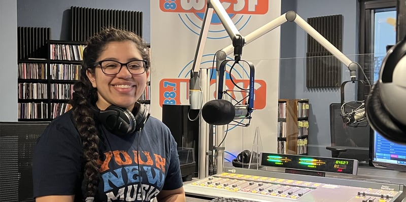 Elvia Cardenas, a communication and media arts major at the University of St. Francis, is producing and hosting the first all-Spanish-language music program on the University's radio station, WCSF 88.7 FM.