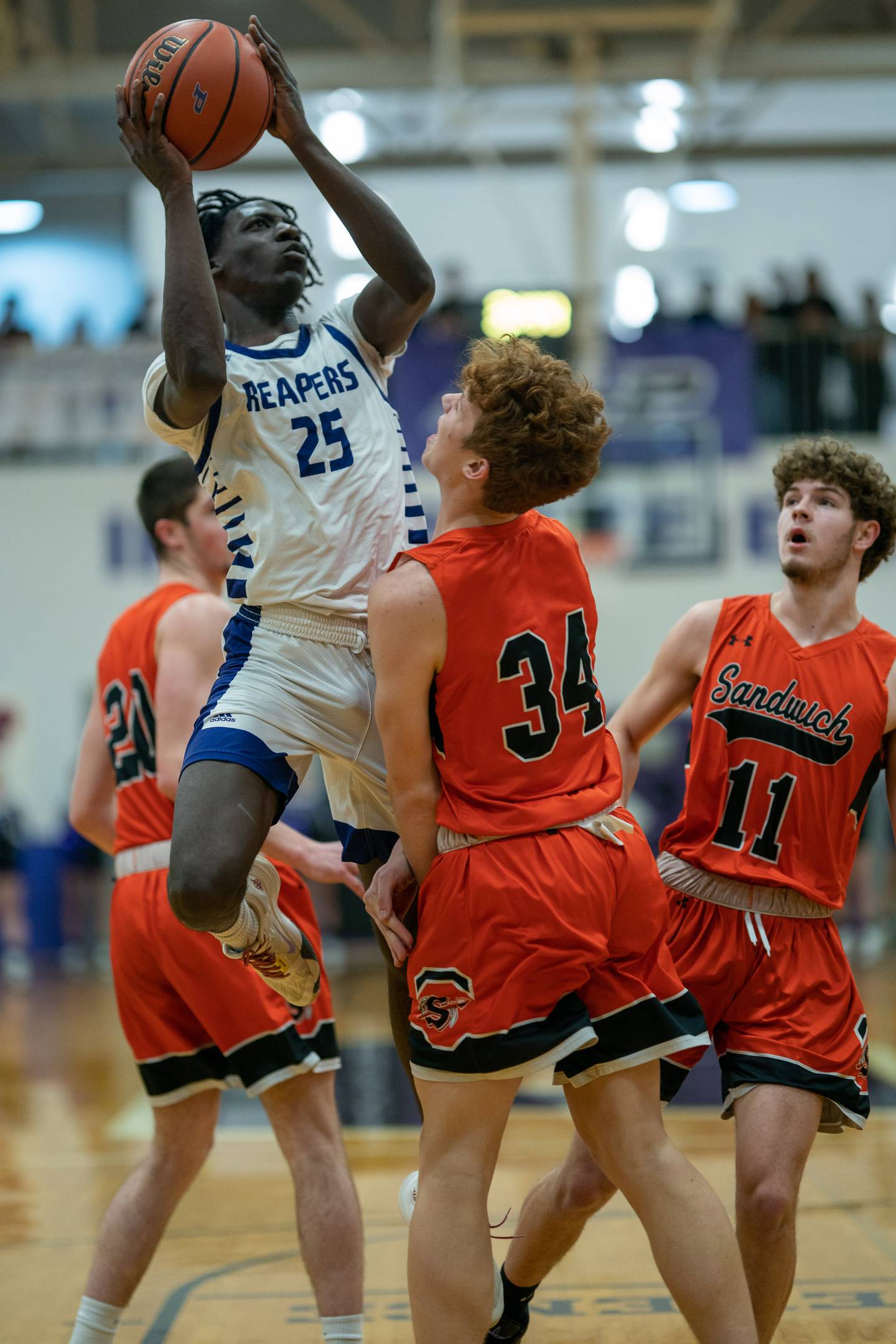 Plano's Christ Keleba (25) shoots the ball in the post against Sandwich’s Dom Rome (34) during a basketball game at Plano High School on Friday, Jan 20, 2023.