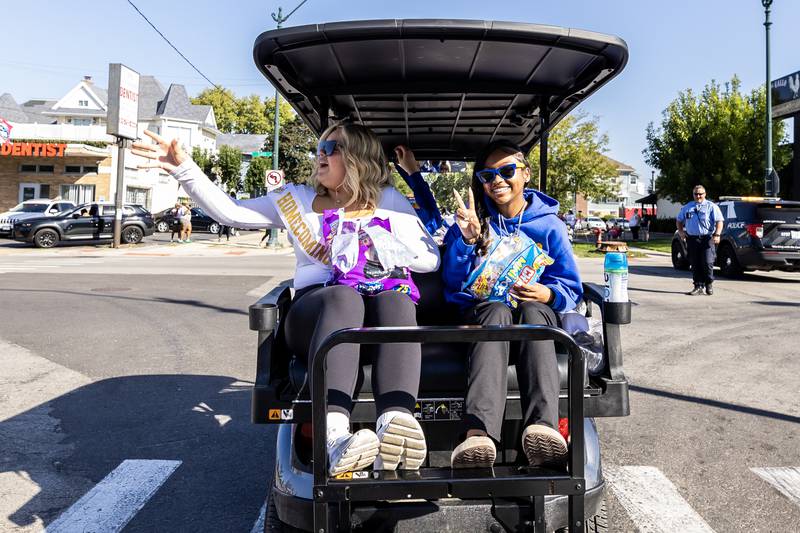 Senior homecoming court members Sophie Litsogannis and Ca’Niyah Williams ride in a golf cart during the Joliet Central homecoming parade on Sept. 27. 2025.