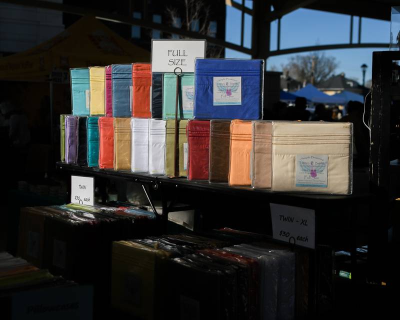 Bed sheets from Simple Pleasure Luxury bedding were for sale at the Wheaton Fren h Market in downtown Wheaton on Saturday April 13, 2024.