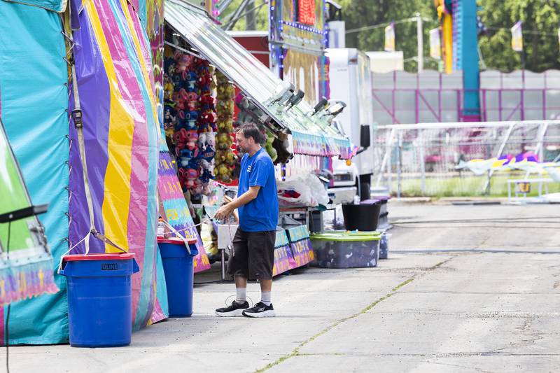 Steven Sanderson sets up a booth Tuesday, July 1, 2025, for Dixon’s Petunia Fest carnival. The carnival will have special needs quiet hours from 2-4 p.m. Wednesday, July 2, and will open up to all at 5 p.m.