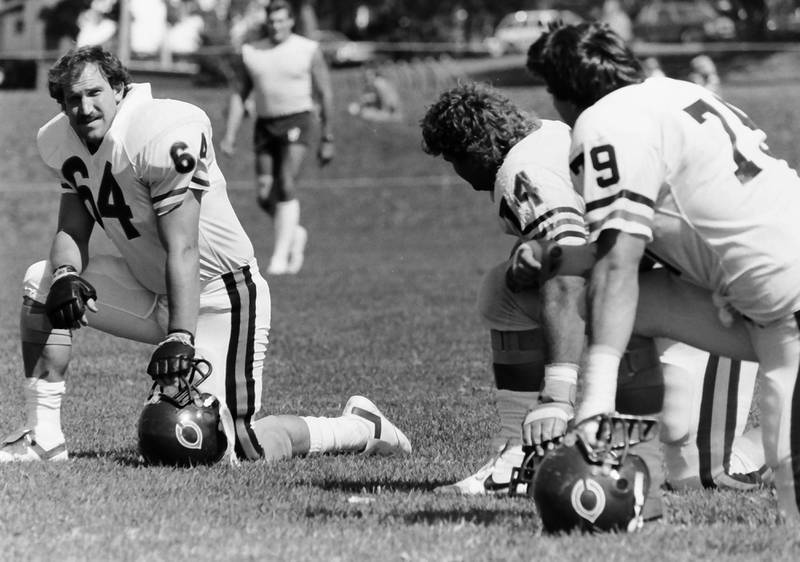 Chicago Bears players (from left) Rob Fada, Jim "Jimbo" Covert and Kurt Becker converse during training camp on Wednesday, June 12, 1985 in Platteville Wis.