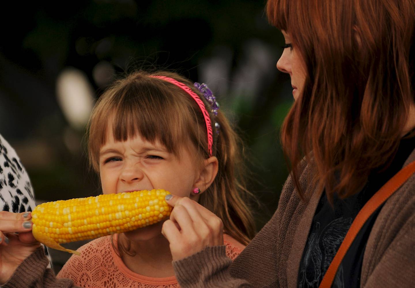 Ashley Korbal shares corn on the cob Friday with her daughter, Lillian, at the Sugar Grove Corn Boil. They live in Lombard and were visiting Kathy Korbal, Ashley's mother.