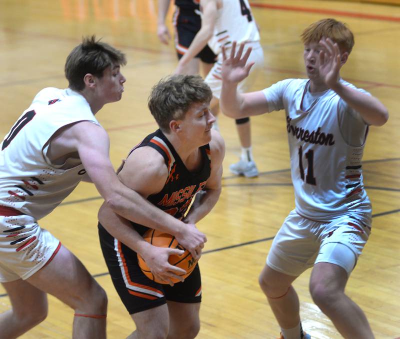 Milledgeville's Karter Livengood (33) makes a move to the basket as Forreston's Brendan Greenfield (0) and Connor Politsch (11) defend on Wednesday, Dec. 18, 2024 at the 63rd Annual Forreston Holiday Tournament.