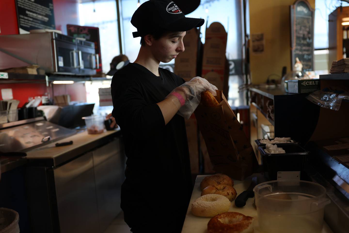 Makayla Vinson puts together an order at Great American Bagel in Joliet.