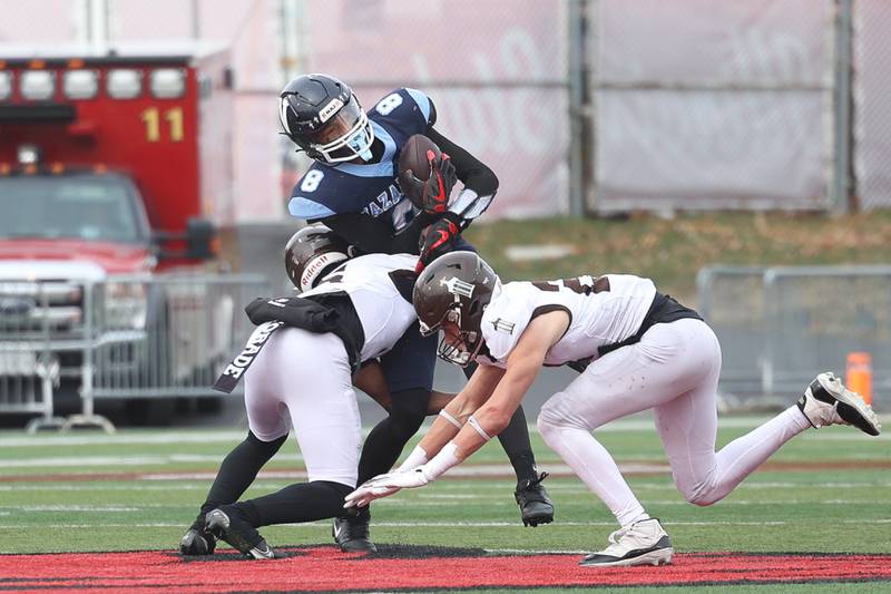 Nazareth’s Trenton Walker gets hit after making a first down catch against Joliet Catholic in the Class 5A state championship on Saturday, Nov. 30, 2024 in Normal.