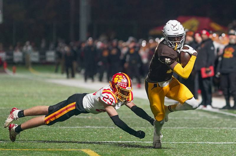 Mt. Carmel's Darrion Gilliam (17) runs after the catch against Batavia’s Josh Kahley (23) during a class 7A semifinal football playoff game at Mt. Carmel High School in Chicago on Saturday, Nov 18, 2023.