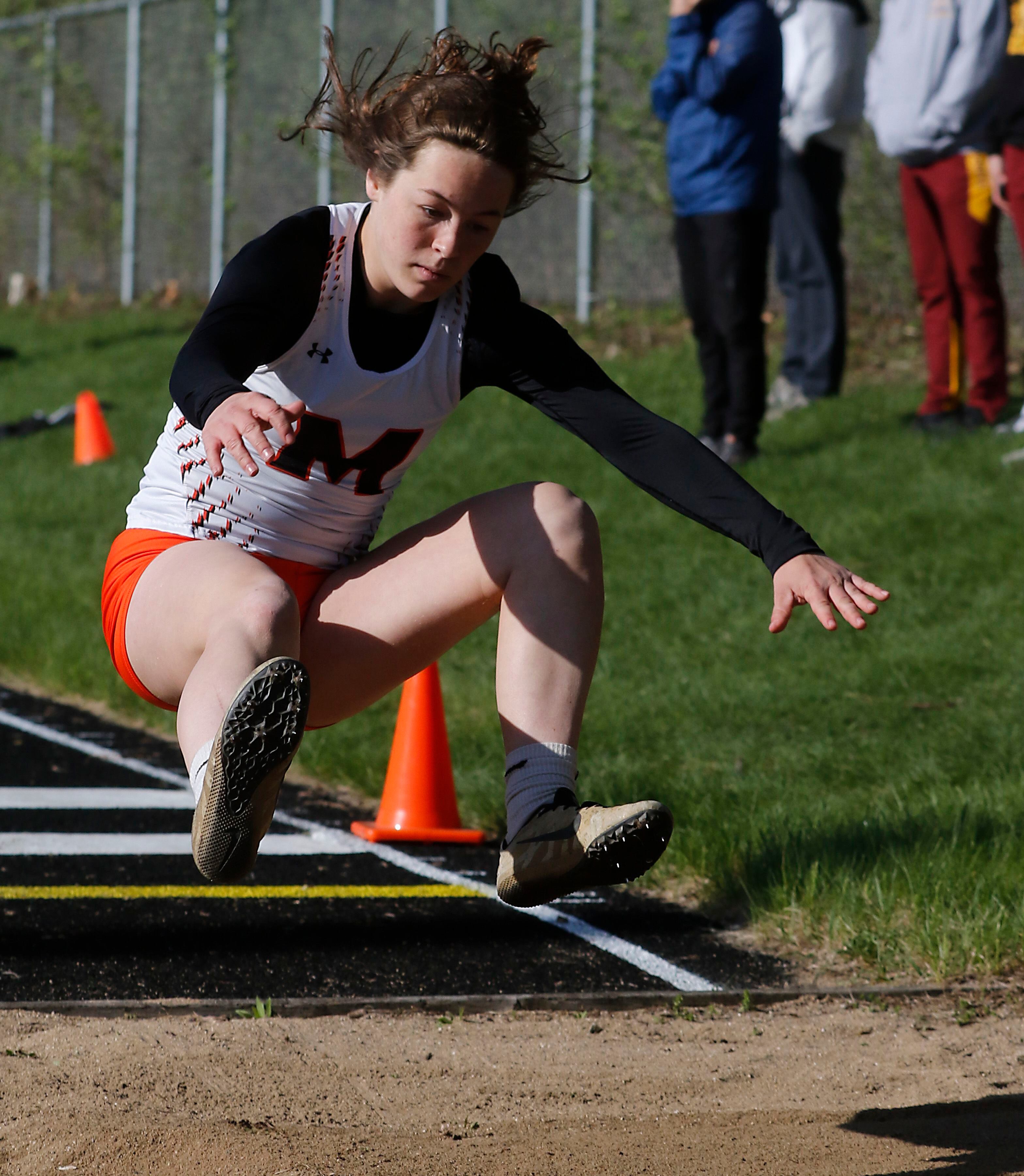 McHenry’s Gabi Grasser competes in the long jump on Friday, April 19, 2024, during the McHenry County Track and Field Meet at Cary-Grove High School.