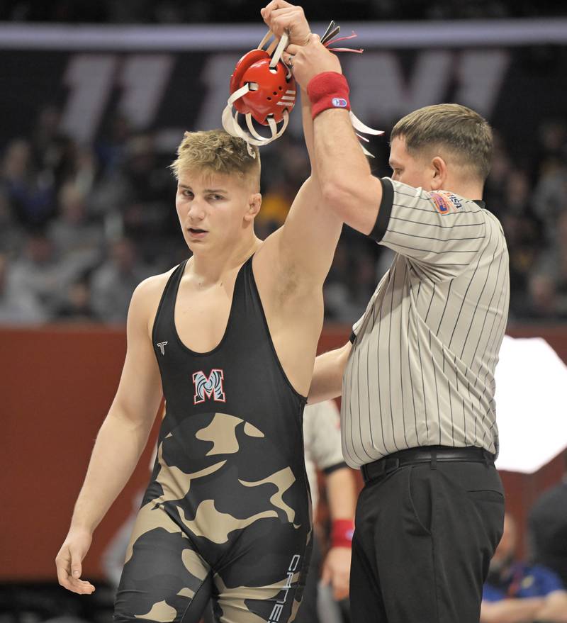 Woodstock Marian’s Jimmy Mastny is declared the winner in the Class 2A 215-pound bout at the boys IHSA wrestling finals at State Farm Center in Champaign on Saturday, Feb. 21, 2026.