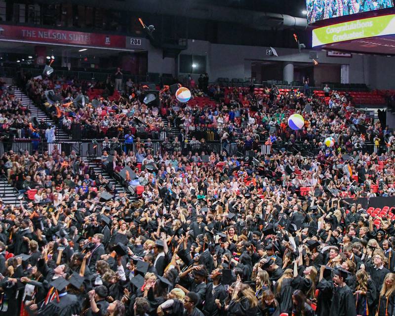Caps and beach balls fly on Saturday, May 24, 2025, after the Class of 2025 Commencement ceremony held at the Convocation Center in DeKalb.