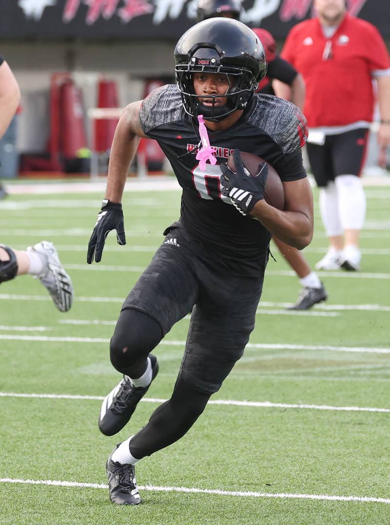 Northern Illinois University wide receiver La'Don Bryant carries the ball Tuesday, April 14, 2026, during a drill at practice in Huskie Stadium at NIU in DeKalb.