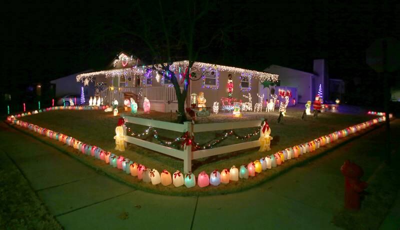 Milk jugs glow around the perimeter of a home located at 623 Calhoun Street on Tuesday, Dec. 20, 2022 in Peru.