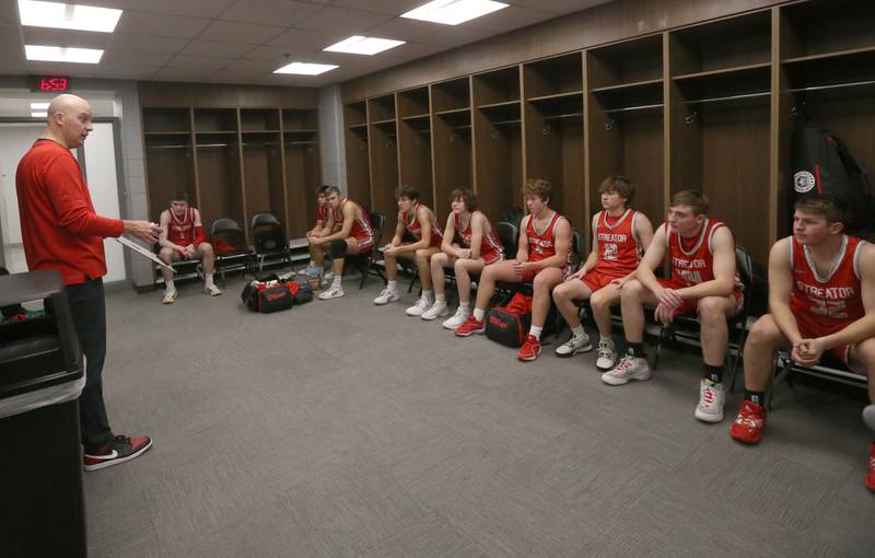 Streator boys basketball head coach Beau Doty talks to his team in the locker room at halftime while playing Seneca in December 2023 at the United Center in Chicago.