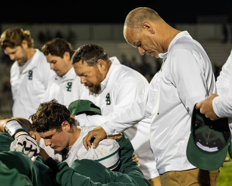 St. Bede Program Assistant Dallas Freeman, puts hand on shoulder of player during team prayer after loss to Seneca on Friday, Oct. 10, 2025 at Seneca High School in Seneca.