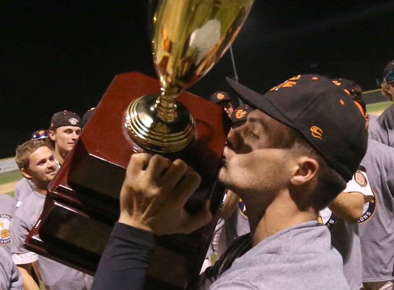 Pistol Shrimp's Jared Herzog of Ottawa, kisses the Prospect League trophy after winning the Prospect League Championship on Wednesday, Aug. 7, 2024 at Schweickert Stadium in Peru.