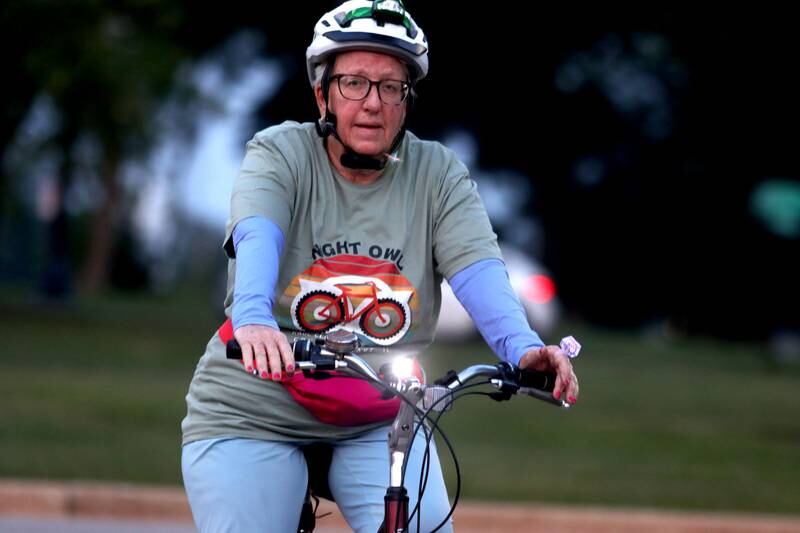 Barb Tegtmeier of Lakemoor warms up before the Raue Center for the Arts Night Owl Bike Ride in Crystal Lake on Saturday, August 2, 2025.