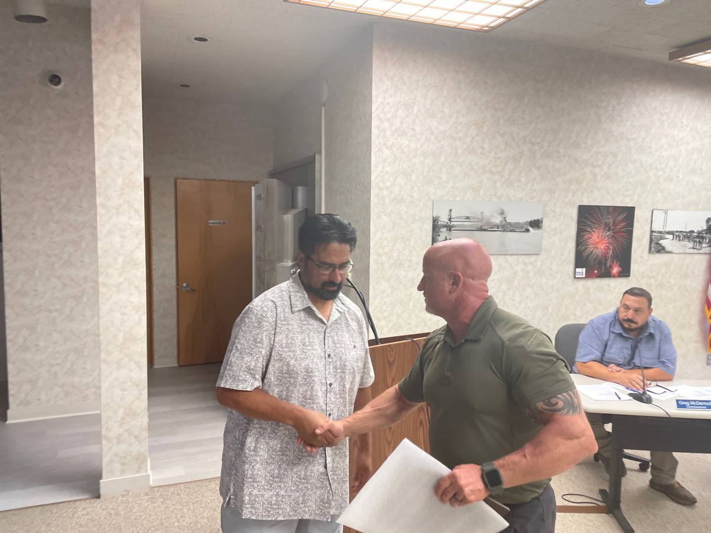James Mandujano (left) accepts a plaque Wednesday, July 5, 2023, at Oglesby City Hall from Commissioner Terry Eutis recognizing Mandujano's 25 years' service to the Oglesby Police Department.