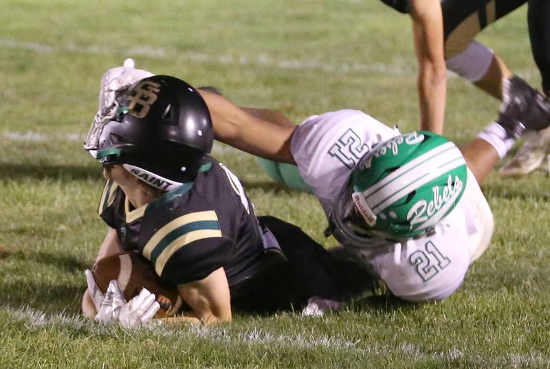 Ridgewood's Julian Luna grabs the helmet of St. Bede's Carson Riva as he falls to the ground on Friday, Sept. 15, 2023 at St. Bede Academy.