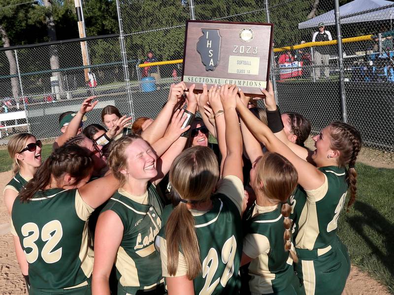 Members of the St. Bede softball team hoist the Class 1A Sectional plaque after defeating Biggsville 3-1 in the Class 3A Sectional championship on Friday, May 26, 2023 at St. Bede Academy.
