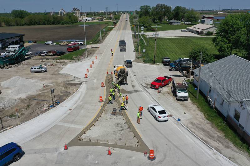 Crews pour concrete on the northern approach to the roundabout on Tuesday, May 16, 2023 at the intersection of Illinois Route 178 and U.S. Route 6 in Utica.