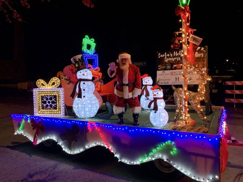 Santa Claus waves to children from a float at the Yorkville Holiday Parade on Nov. 17, 2023.