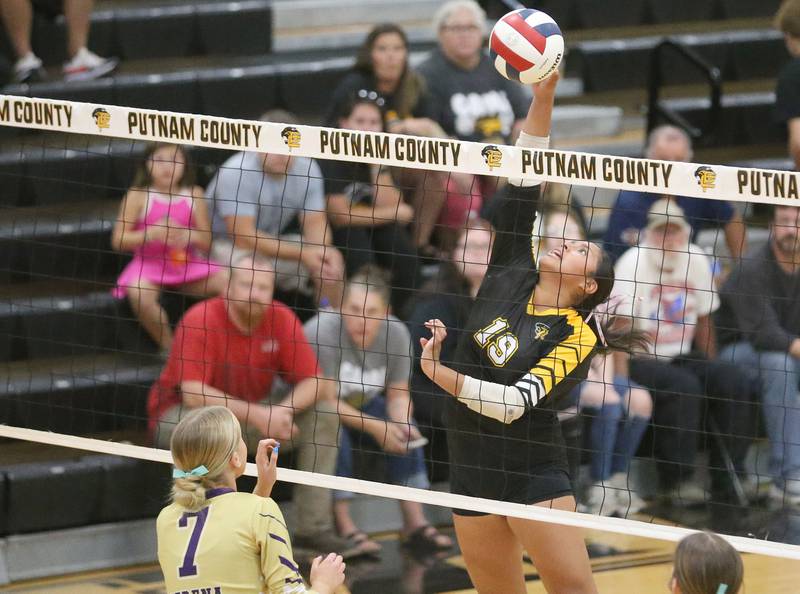Putnam County's Britney Trinidad spikes the ball past Serena's Emily Hoffman on Monday, Sept. 22, 2025 at Putnam County High School.