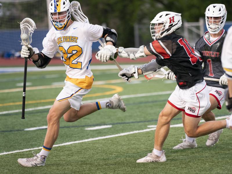 Huntley's Connor Ardell chases down Lake Forest's Jonas Kobza during the boys lacrosse supersectional match on Tuesday, May 31, 2022 at Hoffman Estates High School.