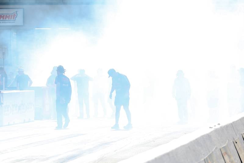 Aaron Stanfield’s crew check the track through the smoke after he did a test start before the Pro Stock championship race at the NHRA’s Gerber Collision and Glass Route 66 Nationals at Route 66 Raceway on Sunday, May 19, 2024 in Joliet.