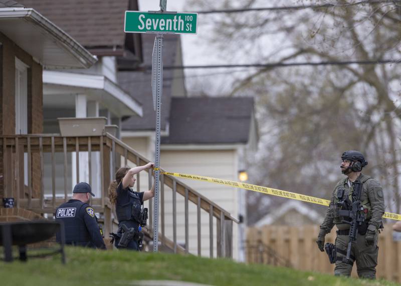 A S.W.A.T Officer watches the local police department putting up caution tape outside of a two-story apartment building on the corner of Seventh and Charters on Sunday, March 30, 2025 in La Salle. A barricaded armed subject fired shots at officers. Police from across the Illinois Valley assisted in the incident.