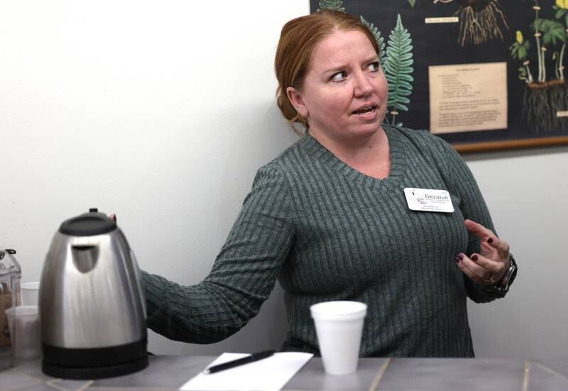 Dezaraé Haley, a U.S. Army veteran and owner of The Herbal Oracle in DeKalb, talks as she gets some tea Thursday, Oct. 10, 2024, at her shop in downtown DeKalb, about her experiences in the service and how her natural holistic living lifestyle has made her family happier and healthier.