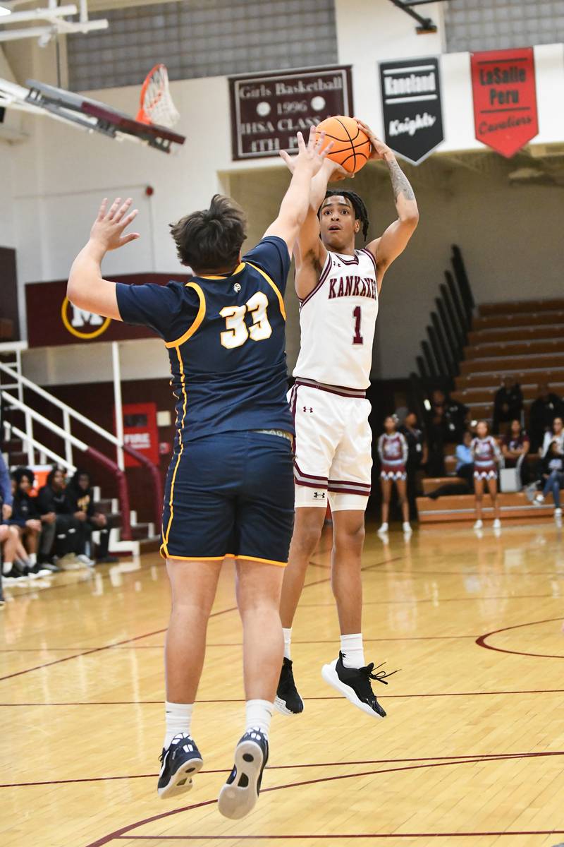 Kankakee's Lincoln Williams shoots over Sterling's Maddux Osborn during the Kays' 85-50 victory over Sterling in the IHSA Class 3A Morris Regional championship on Friday, Feb. 28.